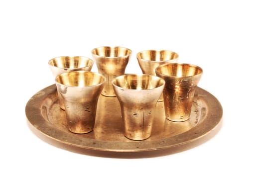The gilt wine-glasses and tray on a white background