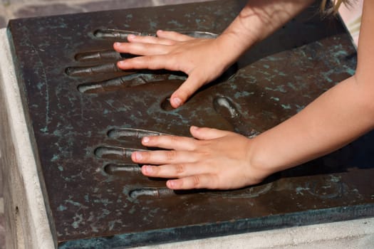 children hands in celebrities metal handprint