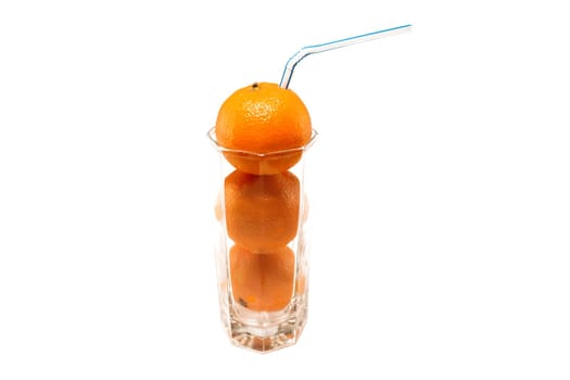 Tangerines with straws in a glass on a white background