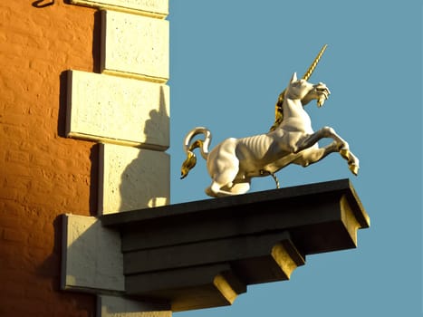 House corner with statue
