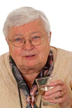 Senior woman drinking a glass of water isolated on white background