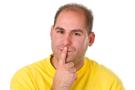 Young man puts his finger on his mouth . Isolated on white background