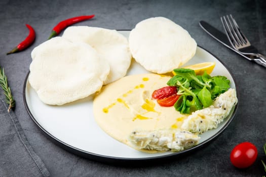 fish steak with rice cakes, cherry tomatoes, lemon and herbs