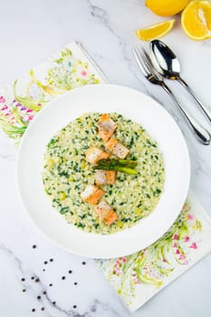 rice porridge with greens, artichoke and pieces of red fish