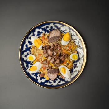 festive pilaf with boiled egg on a dark background