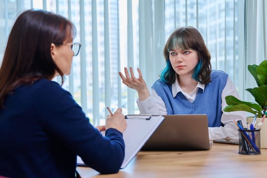 School psychologist, social worker supporting girl student, sitting in office of educational building. Mental health of youth, psychology, psychotherapy, therapy, professional help support