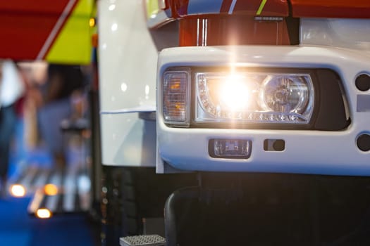 Detailed view of an emergency vehicle's shining headlight.