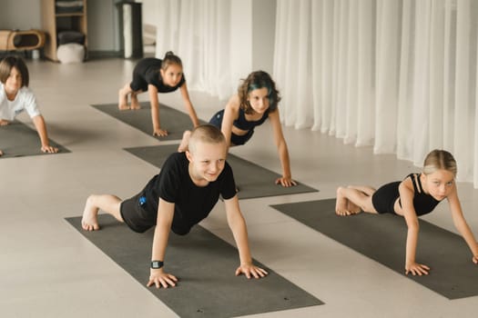 Children do Yoga in the fitness room. Children's gymnastics.