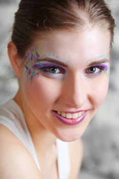 portrait of a pretty young woman with face art