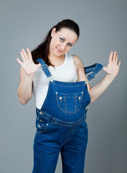 beautiful young pregnant woman with a gray background
