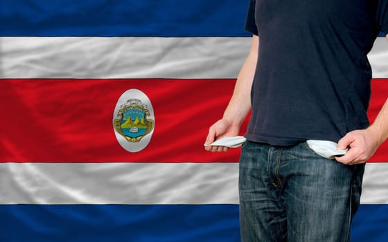 poor man showing empty pockets in front of costarica flag