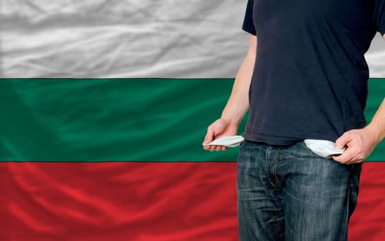 poor man showing empty pockets in front of bulgaria flag