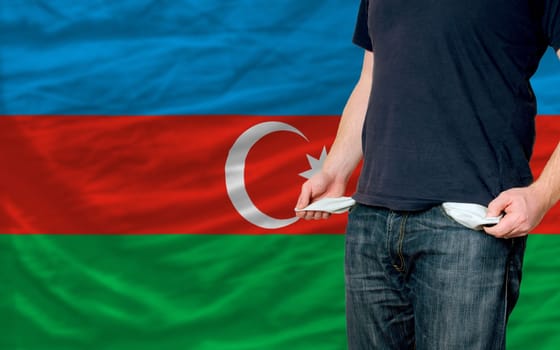 poor man showing empty pockets in front of azerbaijan flag