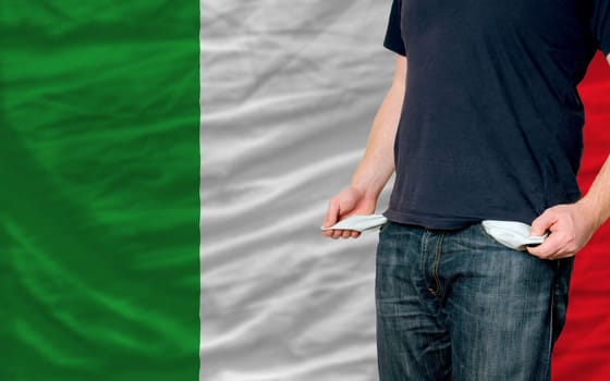 poor man showing empty pockets in front of italy flag