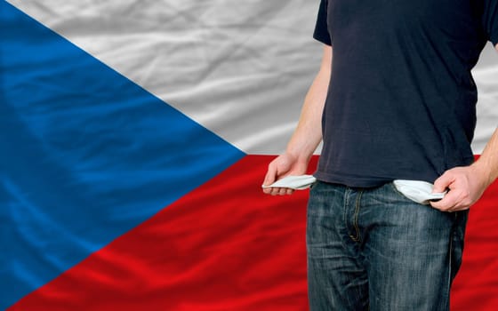 poor man showing empty pockets in front of czech flag