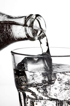 mineral water pouring in to glass close up