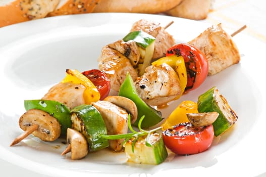 Grilled chicken with vegetables on stick close up