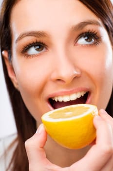 Young woman eating lemon close up shoot