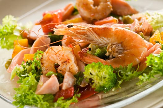 Fresh salad with prawn, salmon and vegetables close up