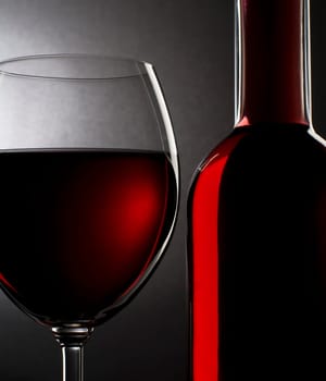 Red wine in glass and bottle close up