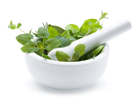 Mortar with herbs isolated on white background