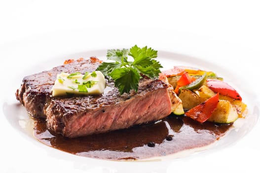 Fresh grilled beef steak on white plate close up