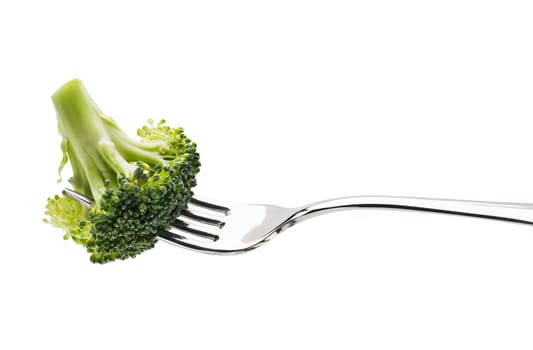 Broccoli on a fork over white background