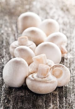 fresh champignon mushrooms close up on wooden table