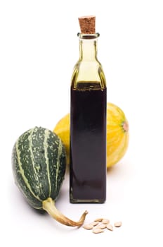 Fresh pumpkin oil close up isolated on white