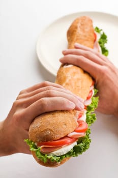 Man holding big sandwich close up shoot