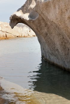 pink granite rock shaped like a wave in Sardinia