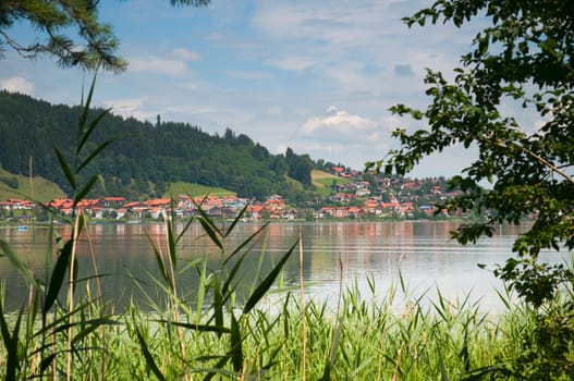 View over the Hopfensee in the Allgäu / Bavaria / Germany to the village of Hopfen am See in summer