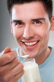 young man eating yogurt close up shoot