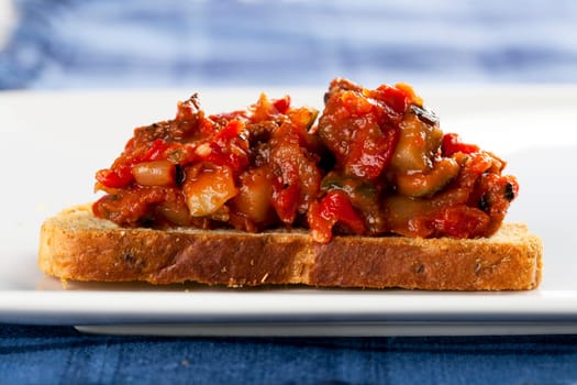 Fresh bruschetta tapas, fresh bread topped with tomato and vegetables.
