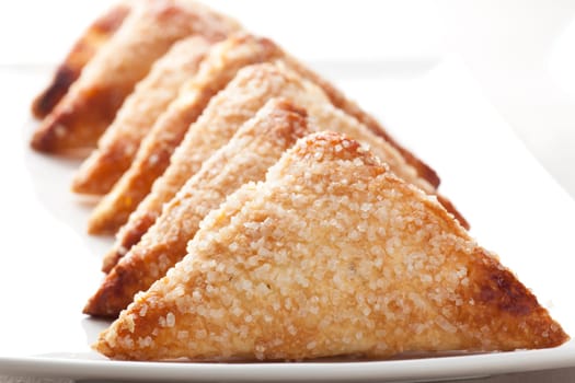 Pastries covered in sugar in a row.