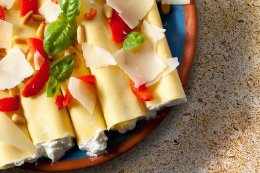 Cannelloni pasta stuffed with ricotta cheese, shot from directly above.