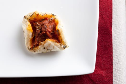 Fresh pastry tapas with tomato filling.