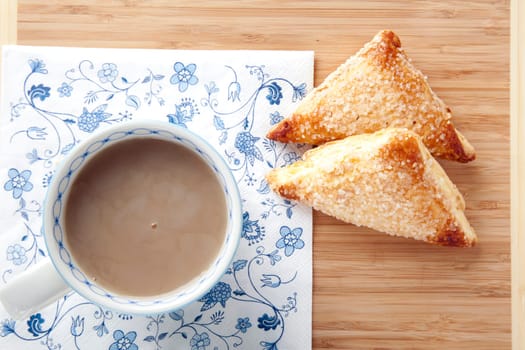Fresh sugar covered scones and a cup of tea.