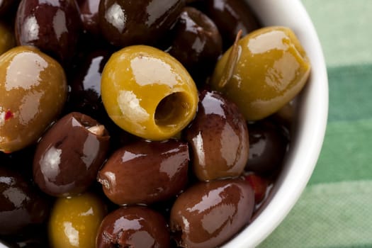Close up of green and black Spanish olives.