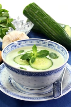 cold cucumber soup with cucumber slices and mint