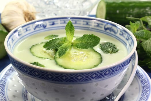 cold cucumber soup with cucumber slices and mint