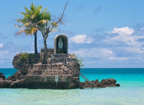 holy maria statue on a rock in the sea on Boracay island, Philippines