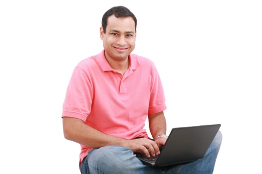 Man sitting on the floor with a laptop - isolated over a white background