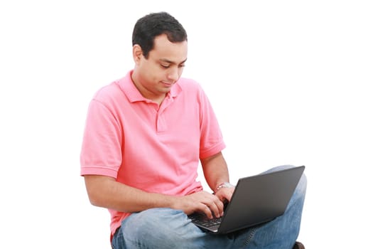 Young man sitting on the floor and work with laptop computer