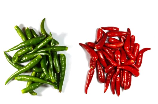 heaps of red and green spicy peppers isolated on white