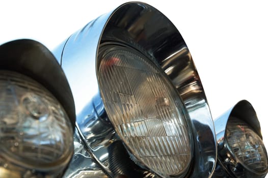 Chromed motorcycle headlights. Close-up. Isolated on white.