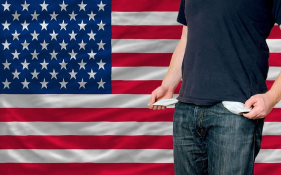 poor man showing empty pockets in front of us flag