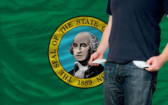 poor man showing empty pockets in front of american state of washington flag