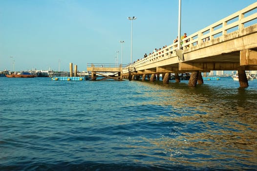 Pier, boats, buildings, beach  modern seacoast urban landscape.