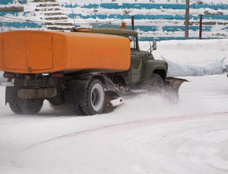 Snow fighter. Ice stadium. Before ice speedway race.